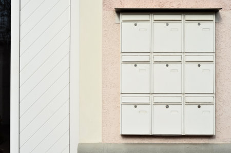 View of white mailboxes on building wallの写真素材