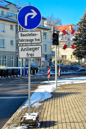View of city street with traffic signs on winter dayの写真素材
