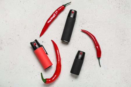 Sprays with chili peppers on light backgroundの写真素材