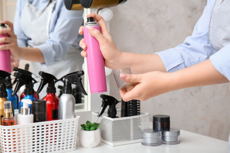 Hairdresser with spray at table in beauty salon, closeupの写真素材