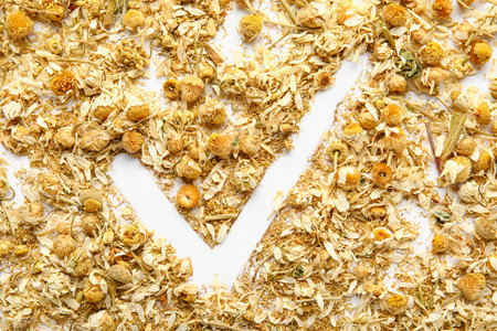 Check mark made of dried chamomile flowers on white backgroundの写真素材