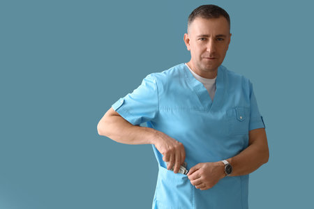 Mature doctor putting bribe in pocket on blue background
