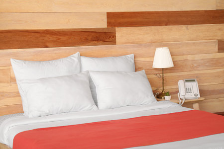 Big comfortable bed in hotel roomの写真素材