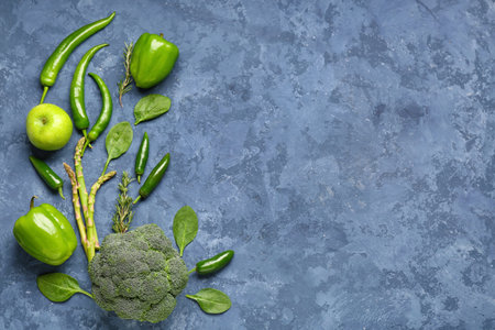 Composition with different fresh green vegetables on blue grunge backgroundの写真素材