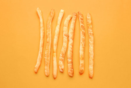 Tasty Italian Grissini on orange backgroundの写真素材