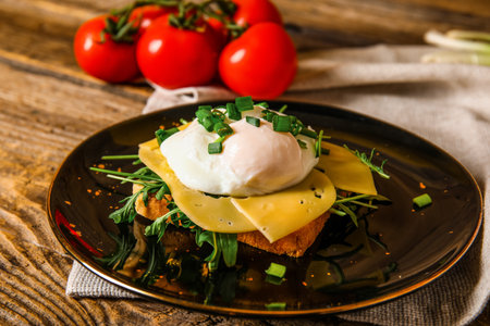 Plate with tasty egg Benedict on wooden backgroundの写真素材