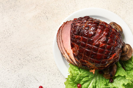 Plate with tasty smoked ham on light backgroundの写真素材