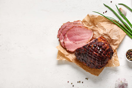 Tasty smoked ham on light backgroundの写真素材