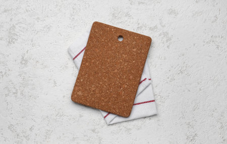 Cork kitchen board and napkin on light backgroundの写真素材
