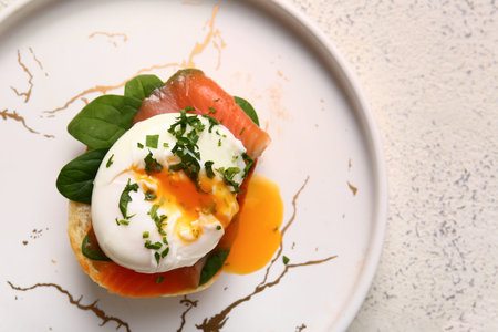 Plate with delicious egg Benedict on table, closeup