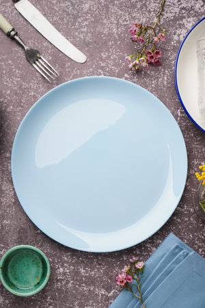 Composition with clean dishes and flowers on gray grunge tableの写真素材