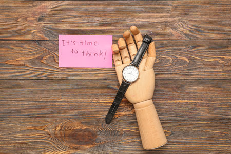 Paper with text IT'S TIME TO THINK, hand and wristwatch on wooden background. insight conceptの写真素材