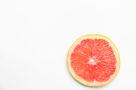Slice of juicy grapefruit isolated on white backgroundの写真素材