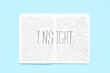 Notebook with word INSIGHT on blue backgroundの写真素材