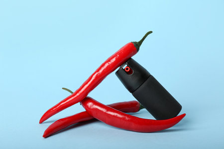 Spray with chili peppers on blue backgroundの写真素材