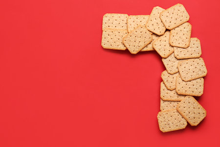 Frame made of tasty crackers on red backgroundの写真素材