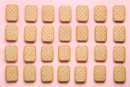 Many tasty crackers on pink backgroundの写真素材