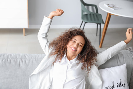 Businesswoman relaxing on sofa after work at homeの写真素材