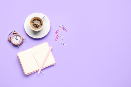 Composition with blank notebook, coffee cup and stationery on purple backgroundの写真素材
