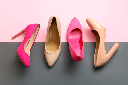 Fashionable high heeled shoes on color backgroundの写真素材