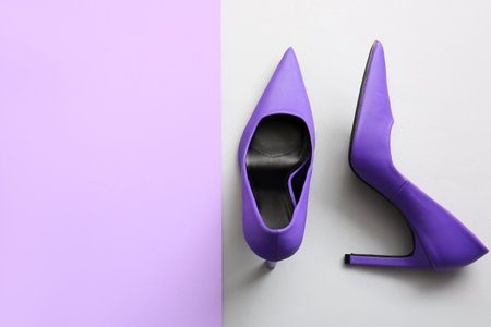 Pair of stylish high heeled shoes on color backgroundの写真素材