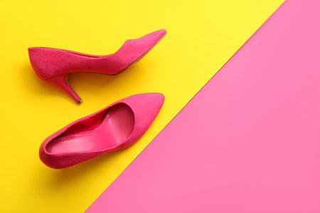 Pair of stylish high heeled shoes on color backgroundの写真素材