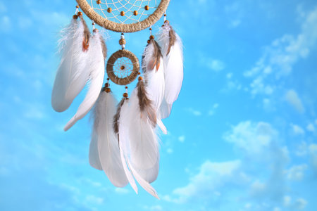Beautiful dream catcher hanging against blue skyの写真素材