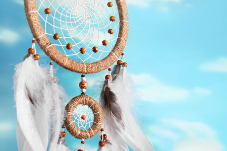 Beautiful dream catcher hanging against blue sky, closeupの写真素材
