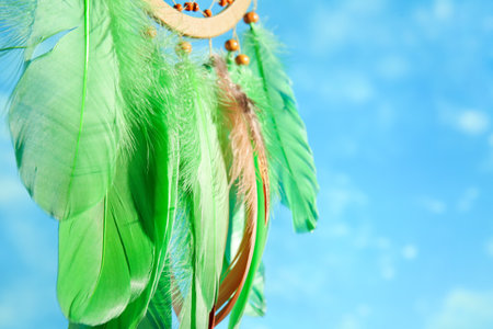 Beautiful dream catcher hanging against blue sky, closeupの写真素材