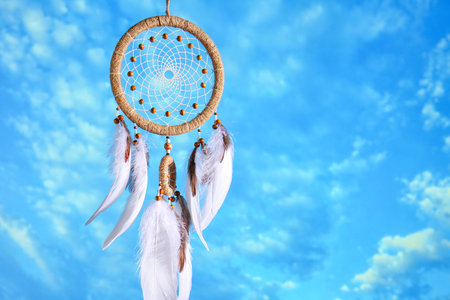 Beautiful dream catcher hanging against blue skyの写真素材