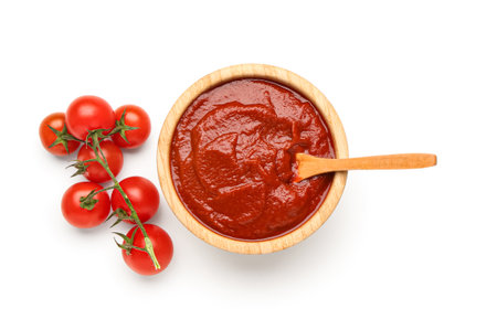 Bowl with tasty tomato paste and fresh vegetables on white backgroundの写真素材