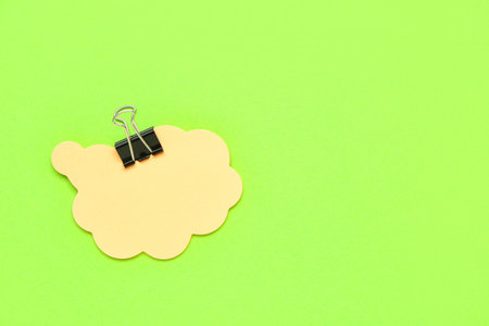 Composition with sticky notes and paperclip on green backgroundの写真素材