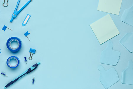 Frame made of different stationery on blue backgroundの写真素材