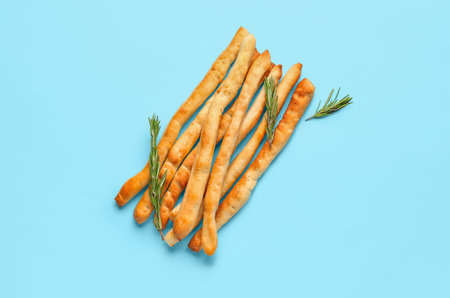 Tasty Italian Grissini on blue background