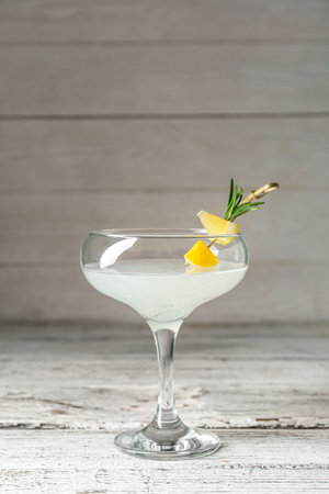 Glass of martini with lemon on wooden tableの写真素材