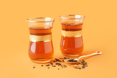 Glass cups of Turkish tea on color backgroundの写真素材