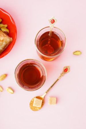 Glass cups of tea with Turkish delight on color backgroundの写真素材