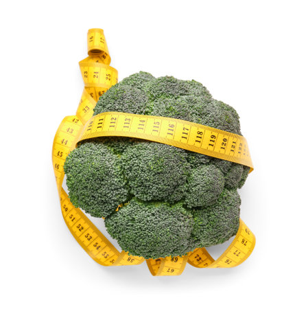 Broccoli and yellow measuring tape on white background. Diet conceptの写真素材