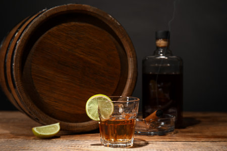 Wooden barrel and glass of cold rum on tableの写真素材