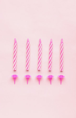 Birthday candles on pink backgroundの写真素材