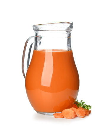 Glass and jug of tasty carrot juice on white backgroundの写真素材