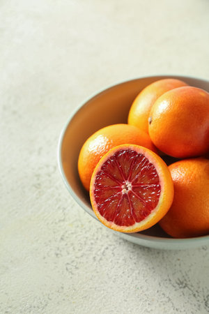 Bowl with tasty blood oranges on light backgroundの写真素材
