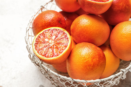 Basket with tasty blood orange fruits on white backgroundの写真素材