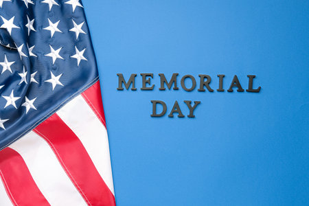 Text MEMORIAL DAY with USA flag on blue backgroundの写真素材