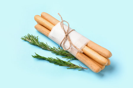 Bunch of tasty Italian Grissini on blue background