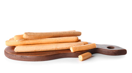 Wooden board with tasty Italian Grissini isolated on white background