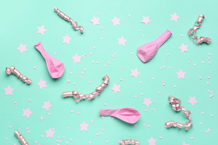 Composition with pink balloons, ribbons, stars and serpentine on blue backgroundの写真素材