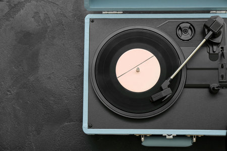 Record player with vinyl disk on dark backgroundの写真素材