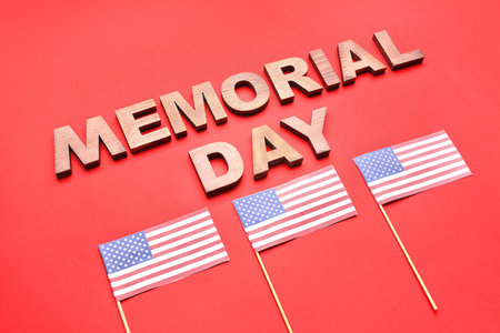 Text MEMORIAL DAY and USA flags on red background