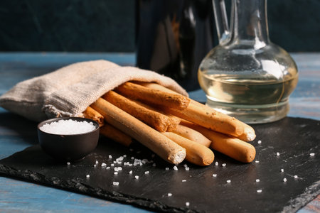 Sack bag with tasty Italian Grissini on tableの写真素材